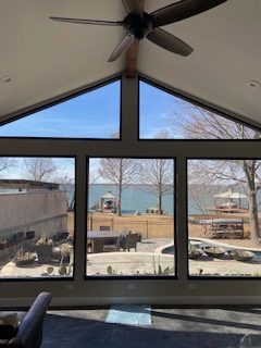 view of lake through large windows with solar film